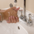 Photo of person washing hands over bathroom vanity sink